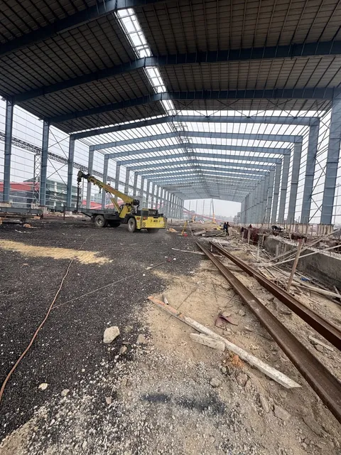 Interior of a large steel shed structure under construction