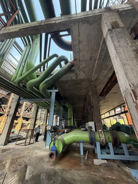 Green piping and supports inside a plant structure