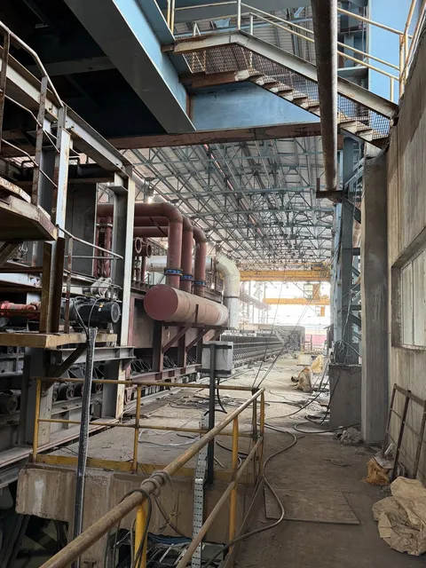 Plant shed interior with piping and an overhead crane