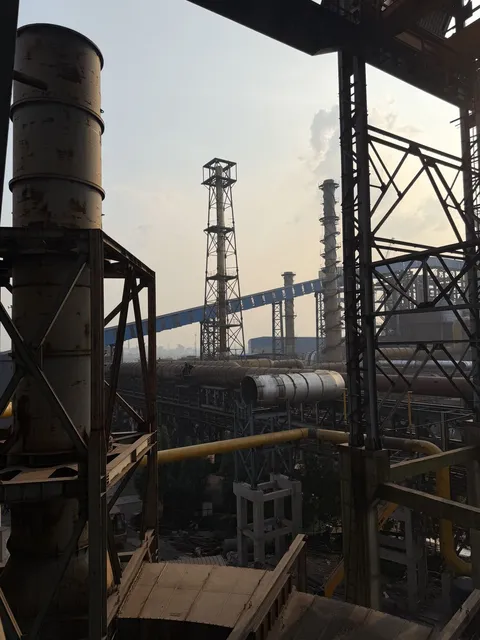 Structural steel platform with a tall stack in the background