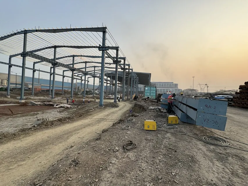 Structural steel framework being erected at an industrial plant site